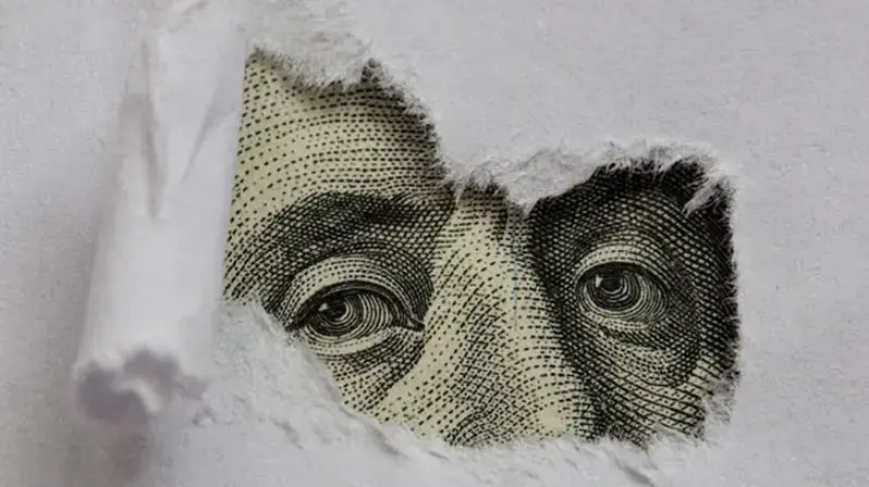 Mit Interim Management Finanz-Herausforderungen lösen: Das Bild zeigt den Kopf auf einer Dollar-Note.